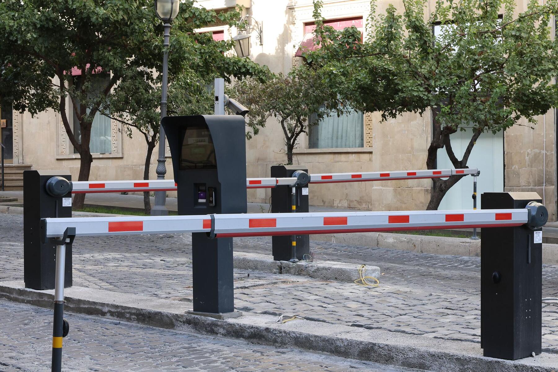 A staffed vehicle entrance with a barrier arm