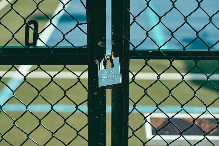 A chain link perimeter fence along a property line