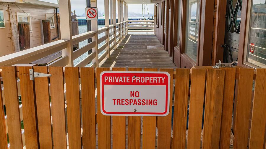 A private property no trespassing sign fixed to a gate